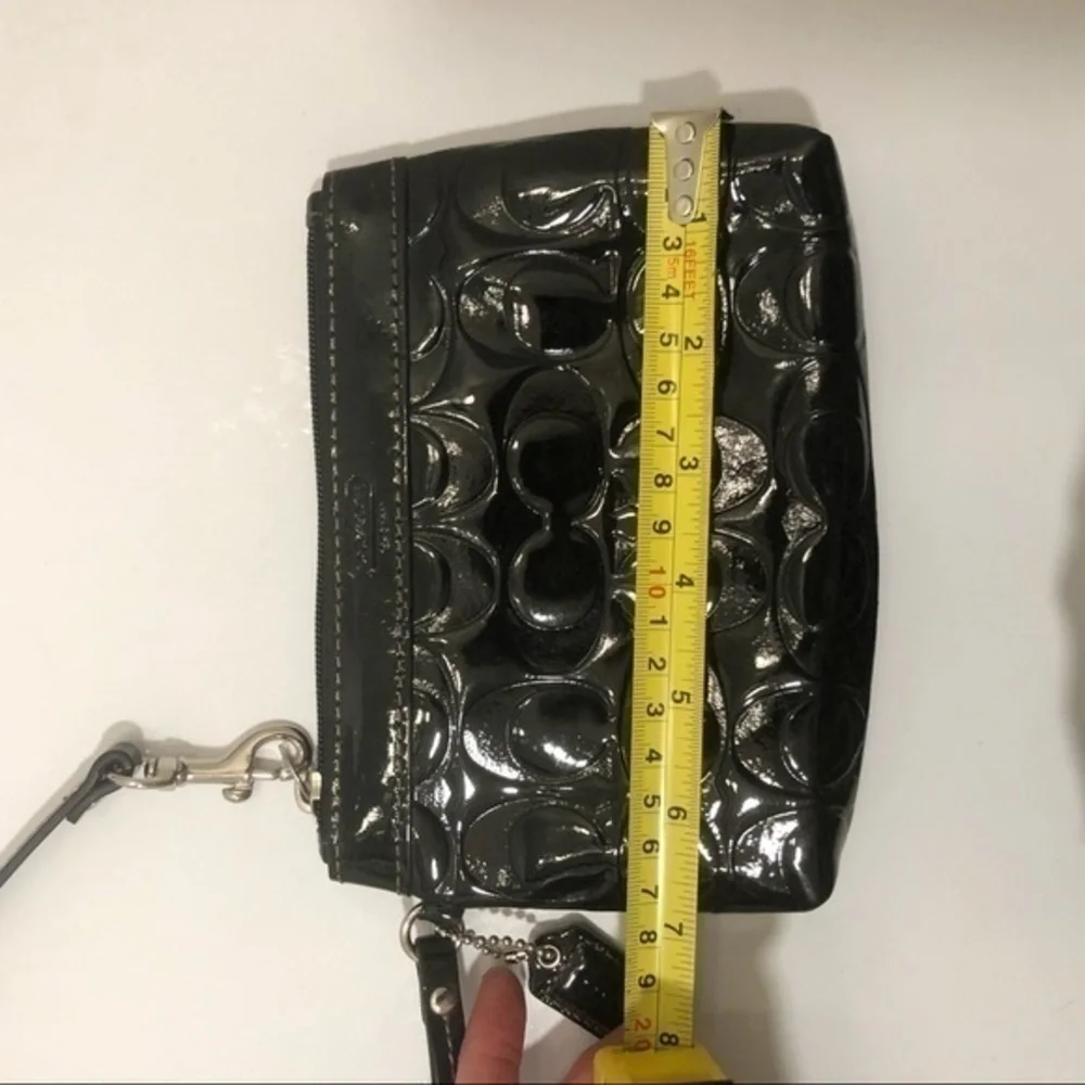 Coach embossed black leather wristlet clutch bag